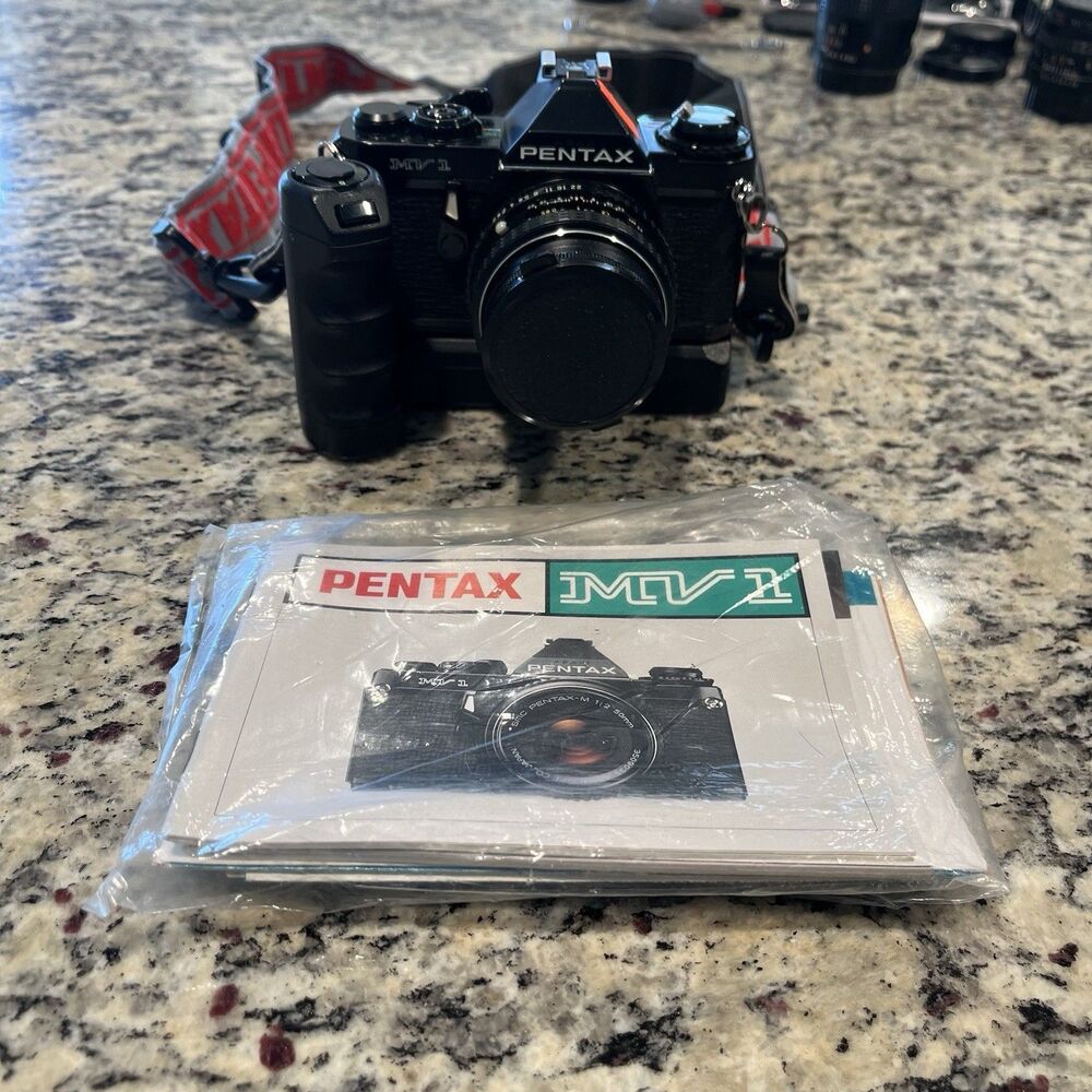 Asahi Pentax MV-1 35mm SLR Film Camera With lens, Mount, Strap and documents
